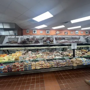 a man walking past a deli counter