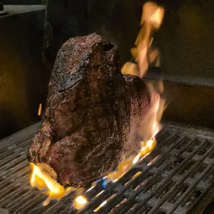 a steak being cooked on a grill