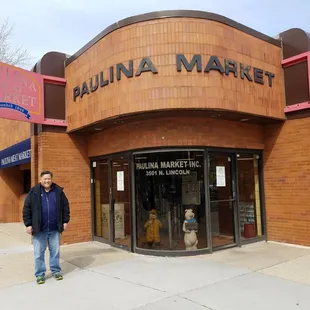 a man standing in front of a store