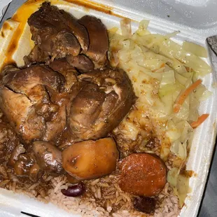 Brown stew chicken with rice with peas and cabbage