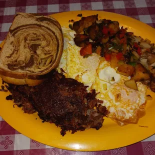 Homemade Corned Beef Hash with breakfast potatoes and two eggs over easy