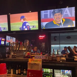 a baseball game being played on tvs