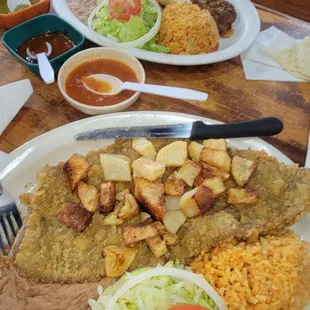 Milanesa plate &amp; guisado plate. The salsas are prime. I did ask for the ranchera salsa, which is the best of them all.