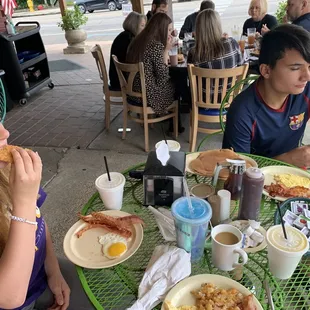 a boy and a girl eating breakfast