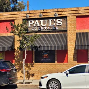 two cars parked in front of the restaurant