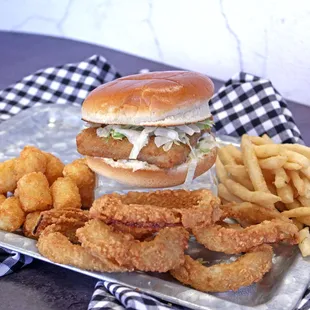 Fish sandwich with all side options fries, tots, and onion rings