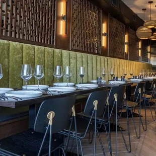 a long dining table with wine glasses on it