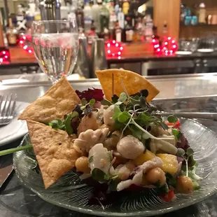 a plate of salad with crackers