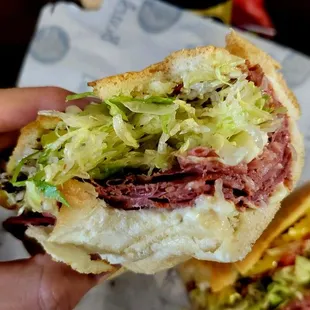 a hand holding a sandwich