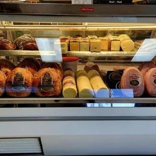 a deli case filled with meat and cheese