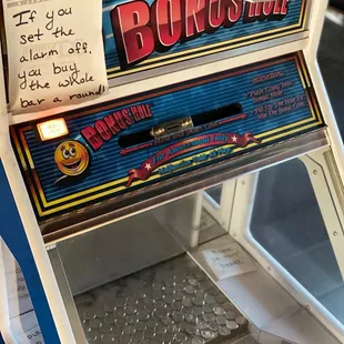 a slot machine with a sign on it