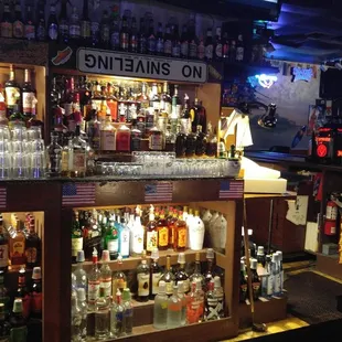 a bar with many bottles of alcohol