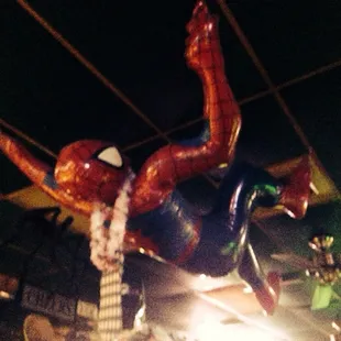 a spider - man hanging from the ceiling