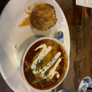 a bowl of soup and a pastry