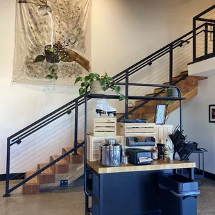 Wall art, flavor cart, and stairs to upstairs sitting area