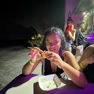 a woman eating a slice of pizza