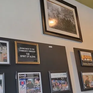 a wall of framed photographs