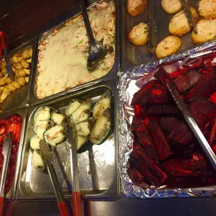 various trays of food with utensils
