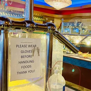 a sign that reads please wear gloves before handling thank you