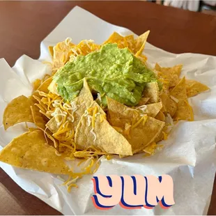 a plate of nachos with guacamole