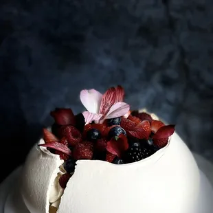 a white cake with berries on top