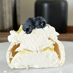 a close up of a pastry with blueberries on top