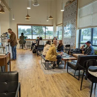a group of people sitting in a coffee shop