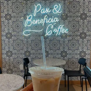 a hand holding a cup of coffee