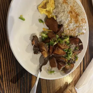 This is "Patrick's Omelette" cheese, Bacon, Sausage, jalapeño smothered in sausage gravy.  With cheese and jalapeños in the potatoes.