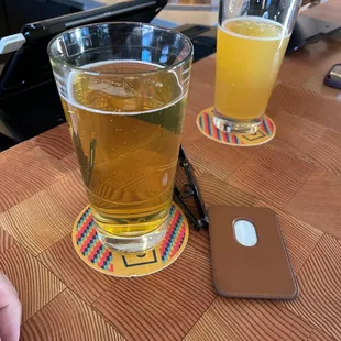 a glass of beer and a cell phone
