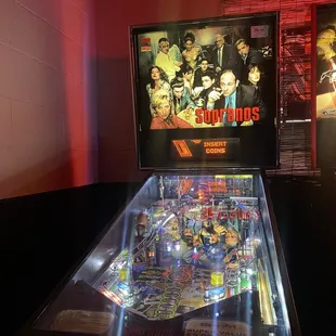 a pinball machine in a dimly lit room