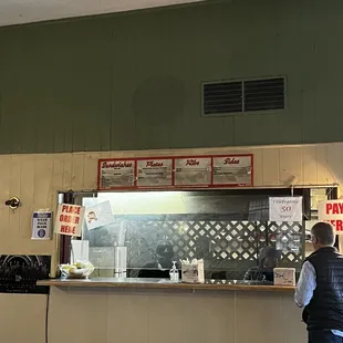 ows a man standing in front of a counter