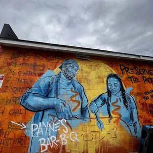 ows a mural of a man and a woman