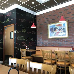 a dining room with a chalkboard wall