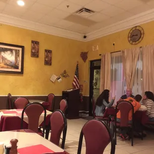 people sitting at tables in a restaurant