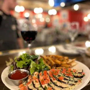 a plate of food and a glass of wine