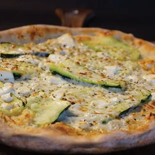 a pizza with zucchini and cheese