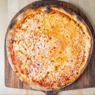 a cheese pizza on a wooden board