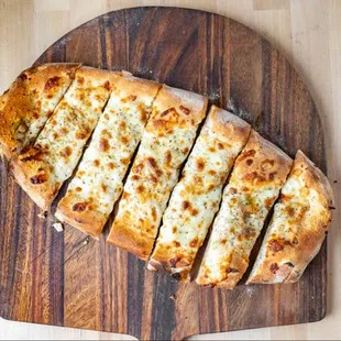 sliced pizza on a wooden cutting board