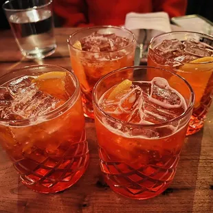 a close up of a table with four glasses filled with drinks