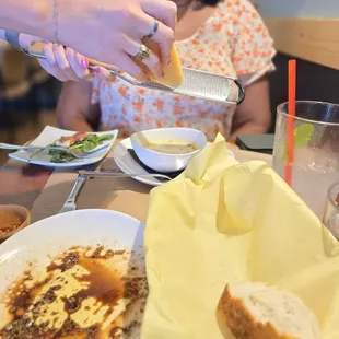 Fresh parmesan getting added to the soup