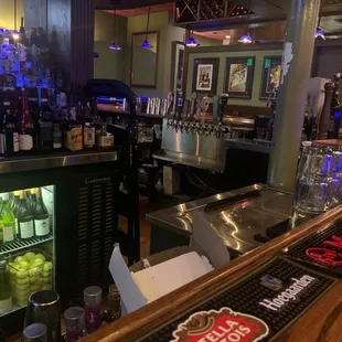 Nice wood bar with 3 sides, 20+ seats, cocktail tables around the walls: Some for 2, some for 4-5. 6 TVs, Pandora playing, lights down low.