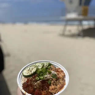 a person holding a bowl of food