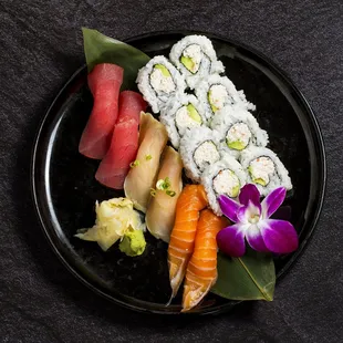 a plate of sushi with a flower