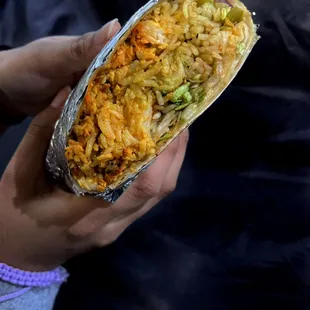 a person holding a burrito