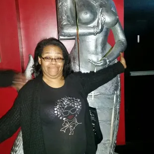 a woman standing in front of a statue