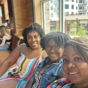 three women sitting on a bench