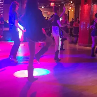 a group of people dancing at a party