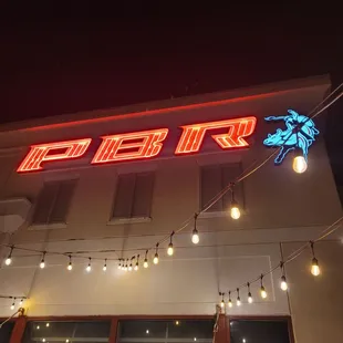 a neon sign on the side of a building