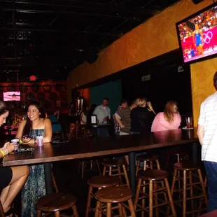 a group of people sitting at a bar